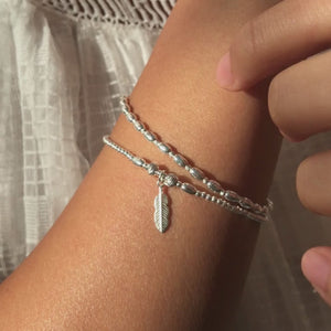 Minimalist Feather bracelet stack with dazzling multicut silver beads