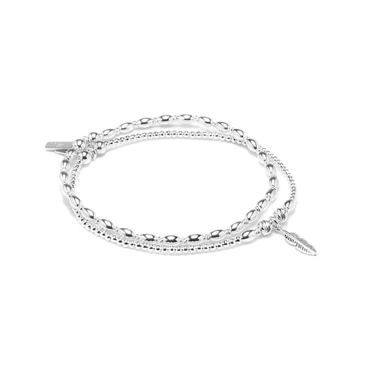 Minimalist Feather bracelet stack with dazzling multicut silver beads