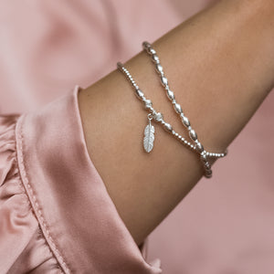 Minimalist 925 sterling silver bracelet stack with Feather charmMinimalist Feather bracelet stack with dazzling multicut silver beads